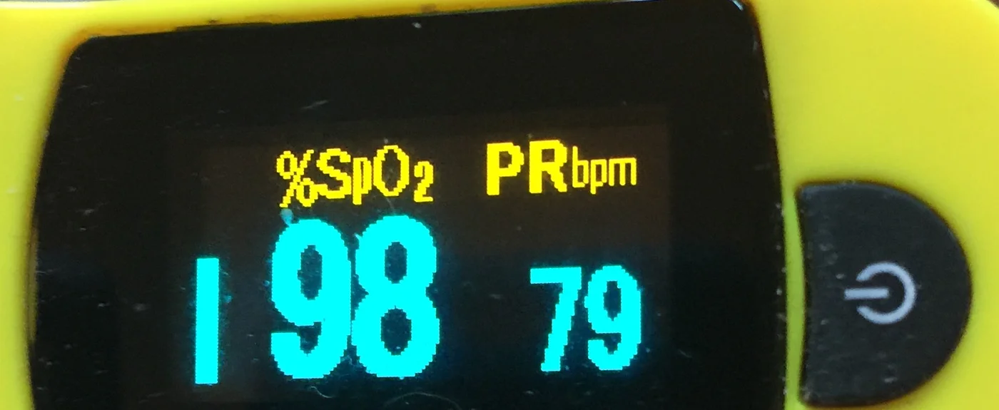 Display eines Fingerpulsoxymeters mit SpO₂ 98 Prozent und Pulsfrequenz 79 pro Minute.